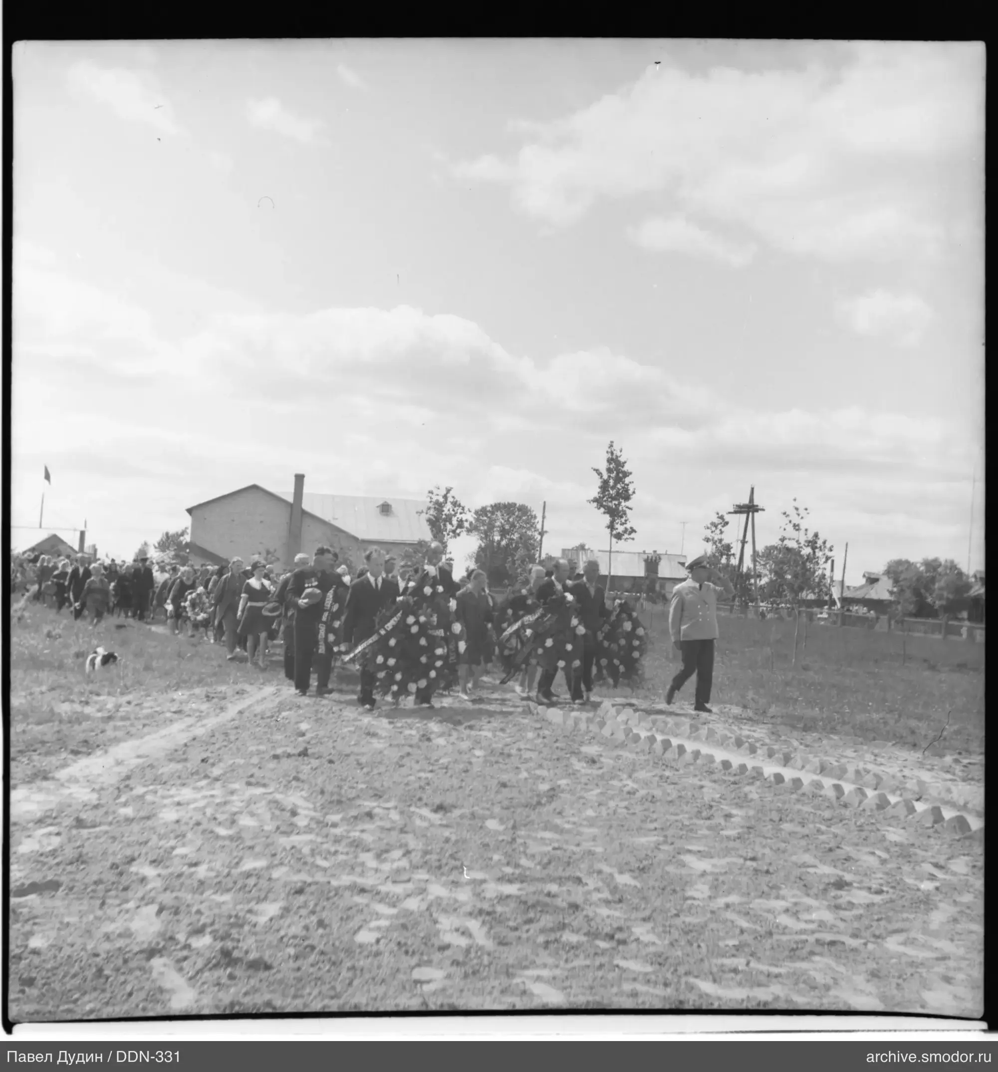 Group of people with wreaths and a dog