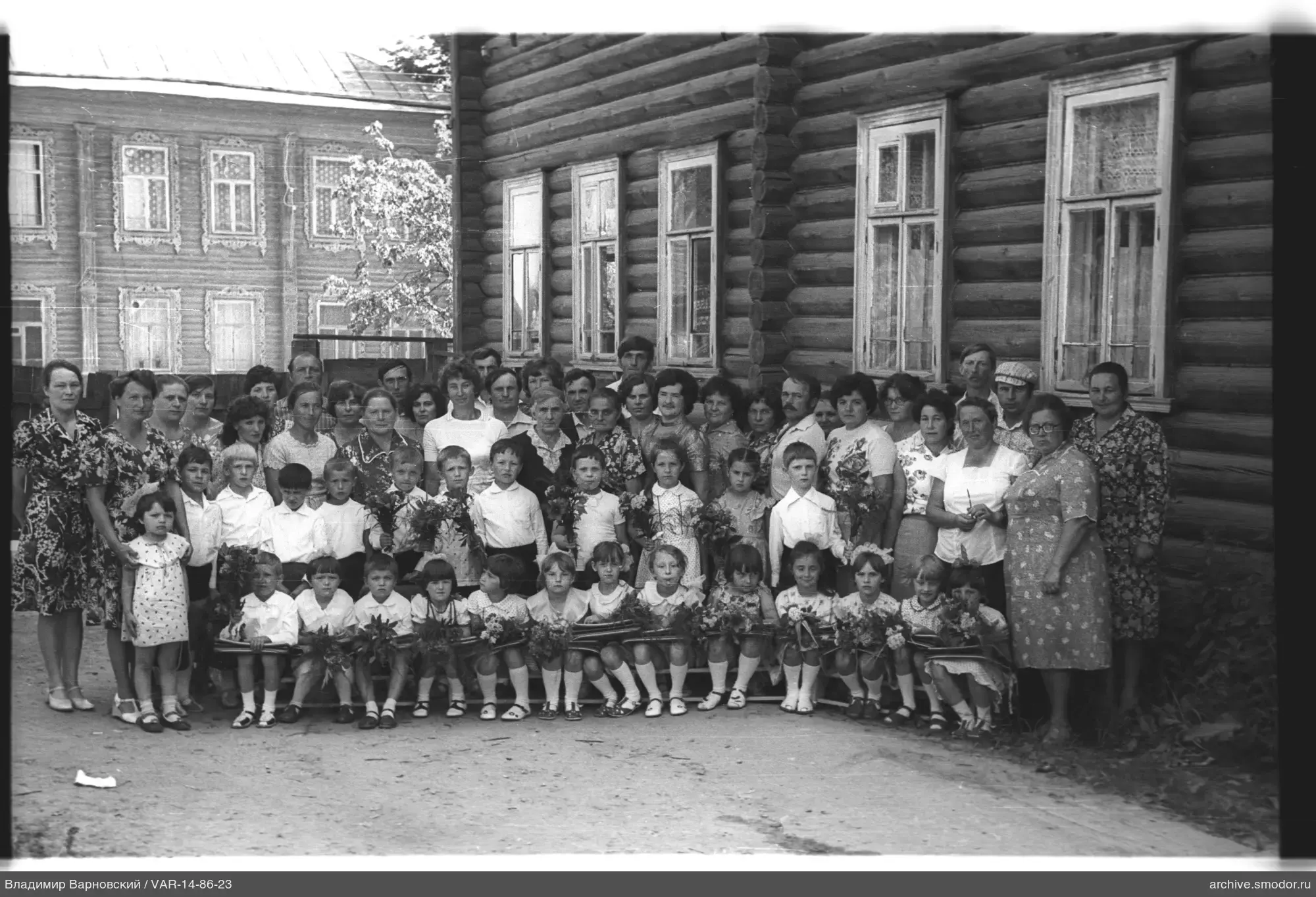 Group portrait near wooden building