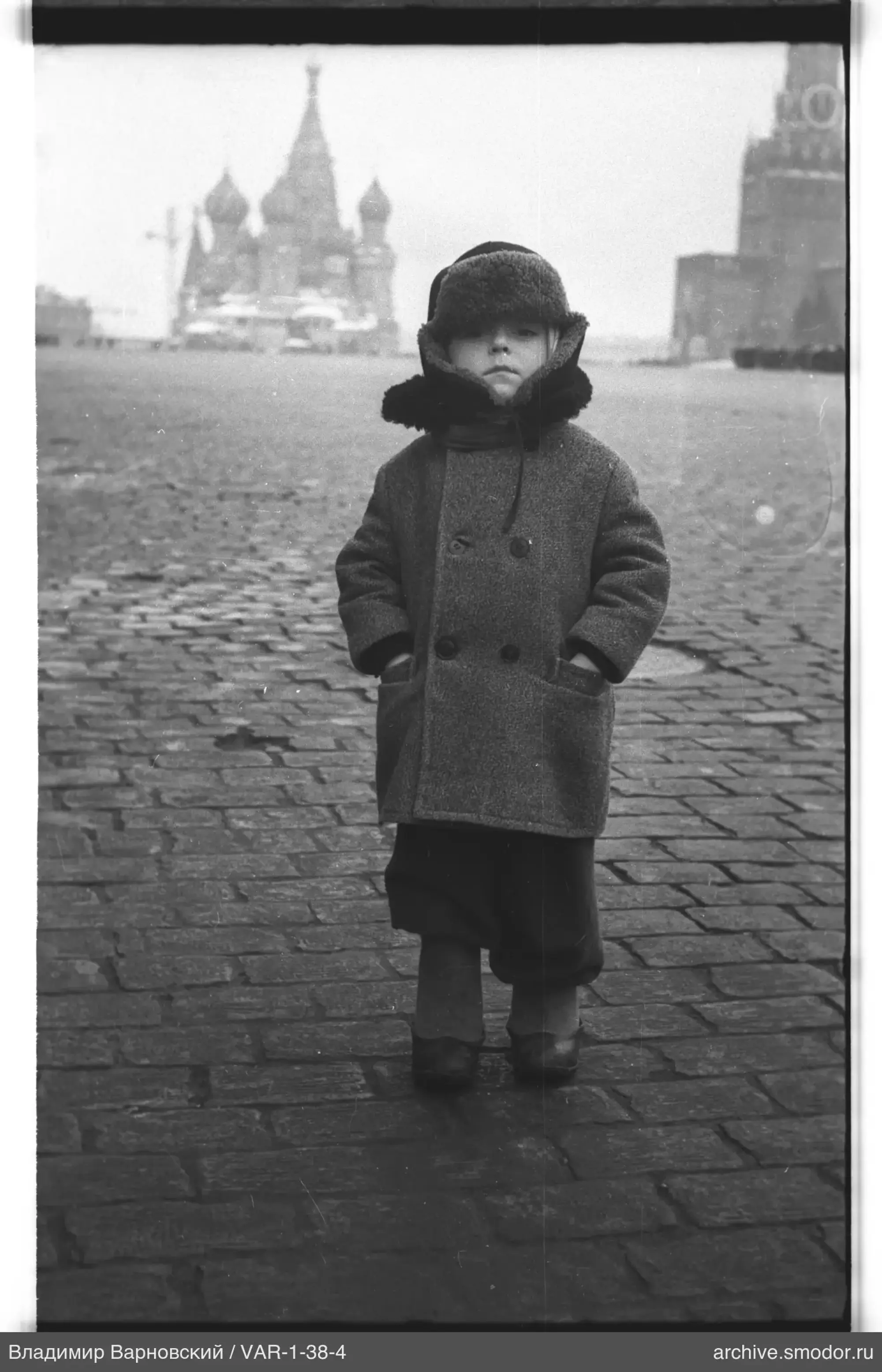 Child on square with cathedral and clock tower