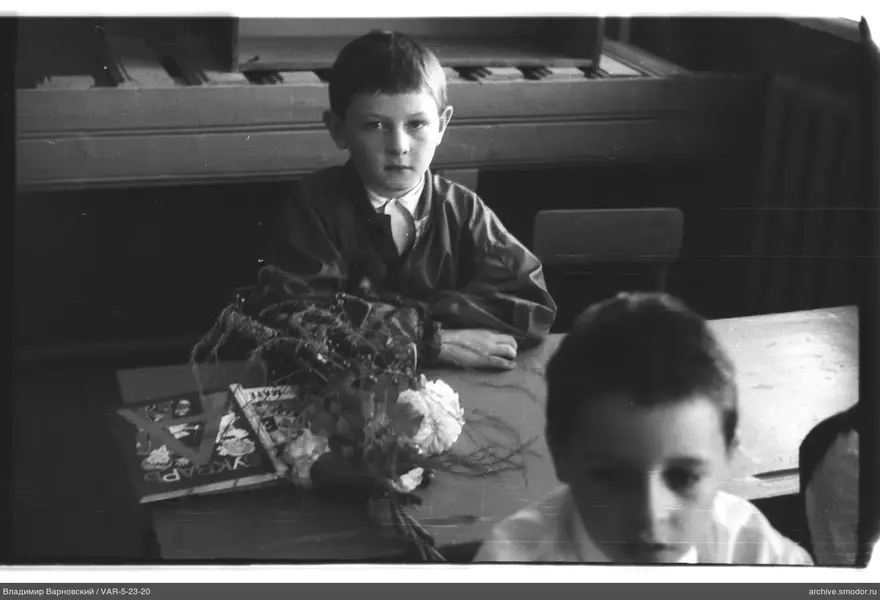 Boy sitting at a desk with books