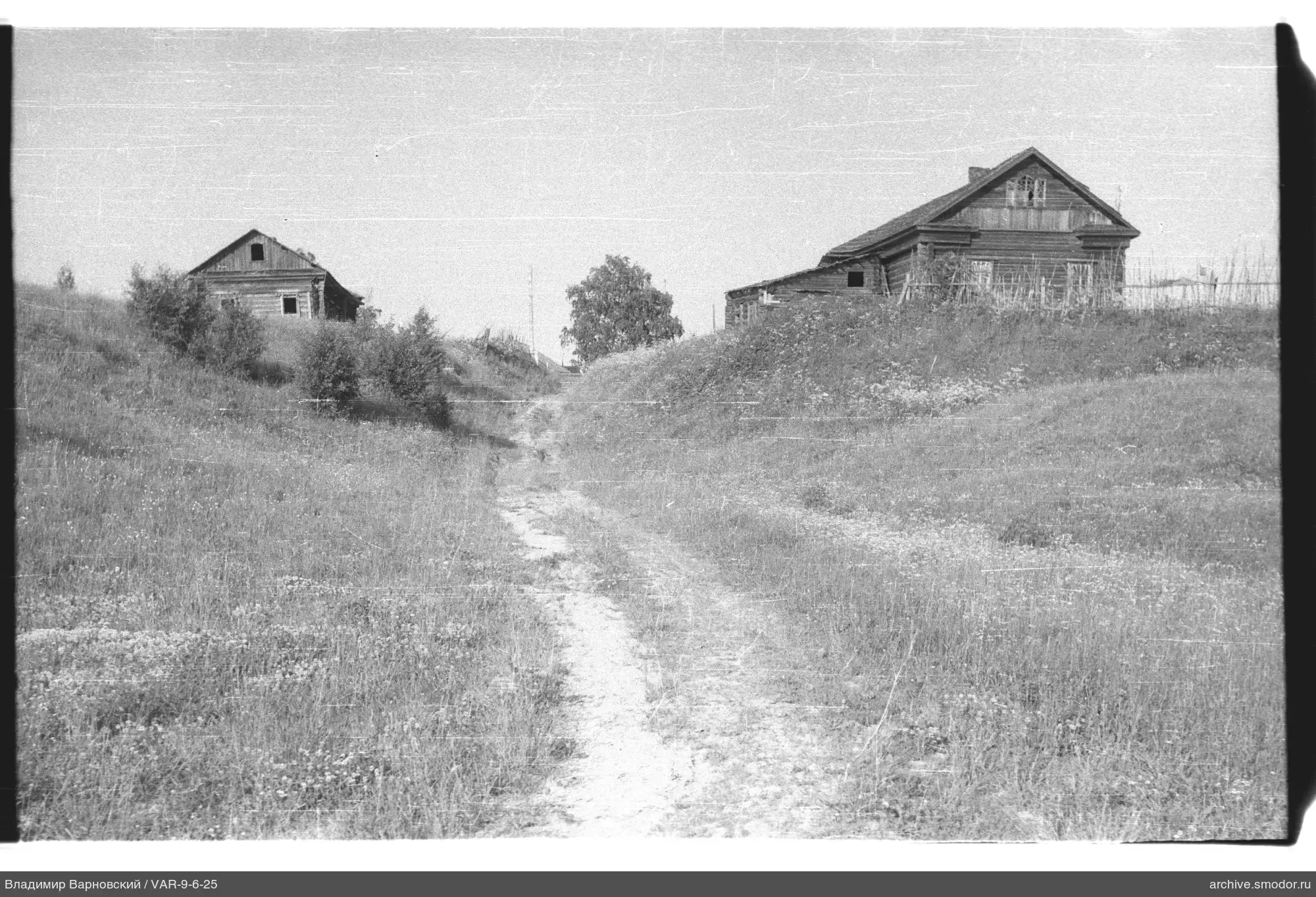 Two wooden huts on elevated land