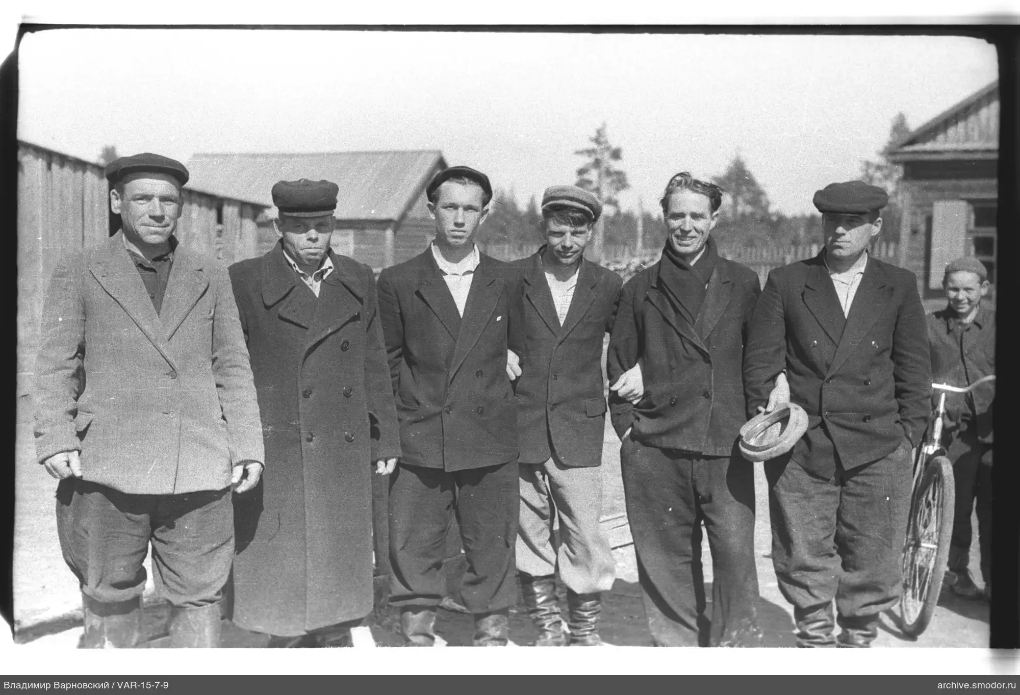 Group of men and boy with bicycle