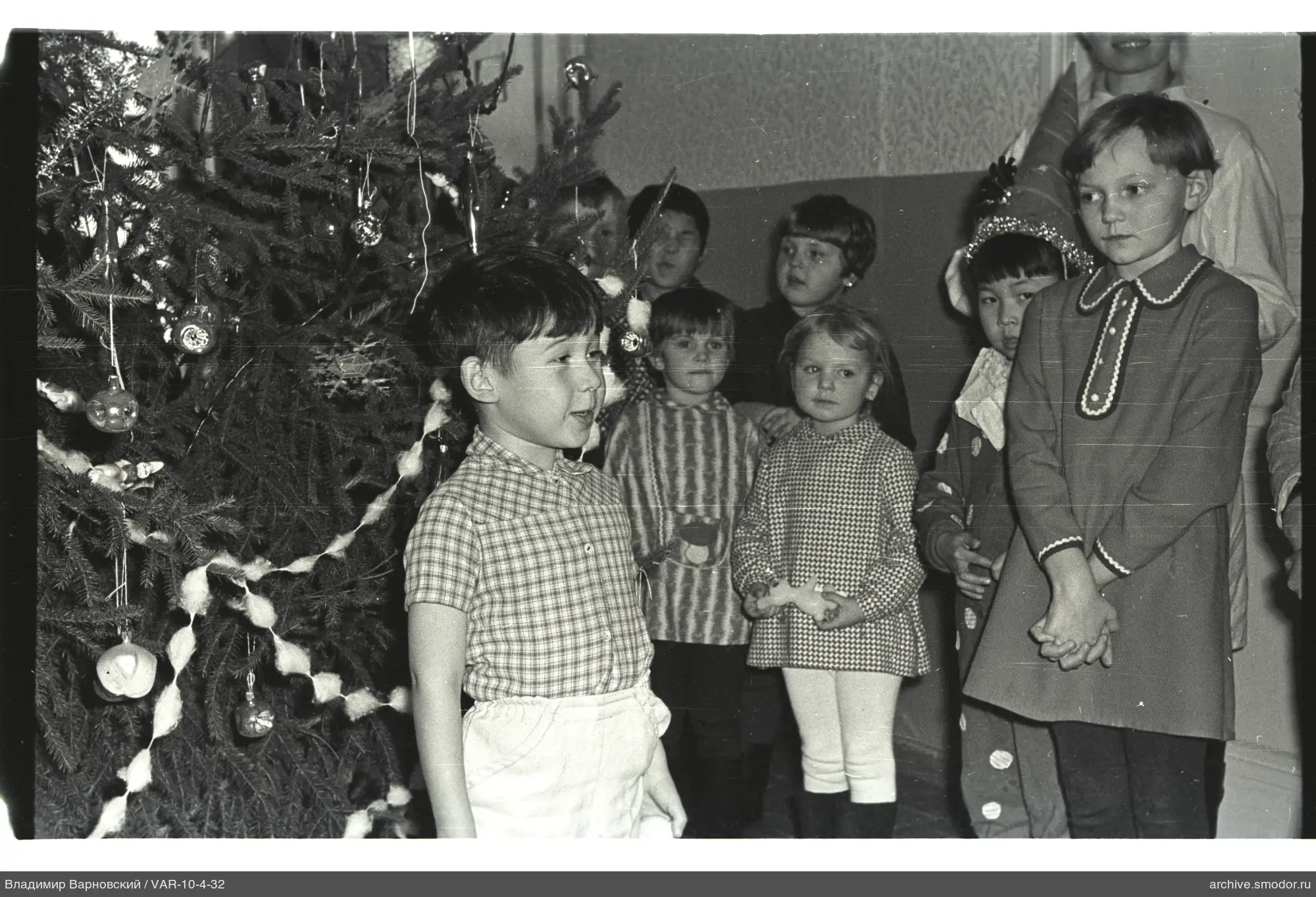 Children by decorated Christmas tree