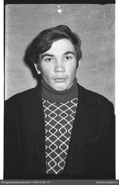 Portrait of a man in a dark jacket and sweater