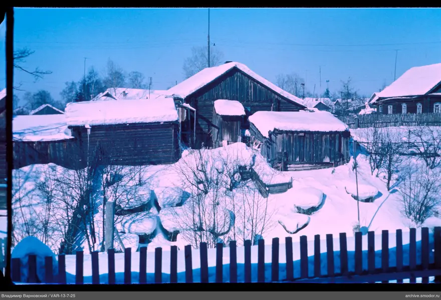Wooden buildings with snow-covered roofs