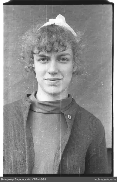 Portrait of a woman with headband and patterned sweater