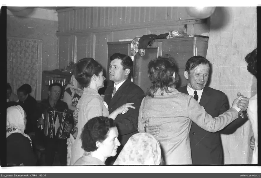 Dancing couples and bayan player