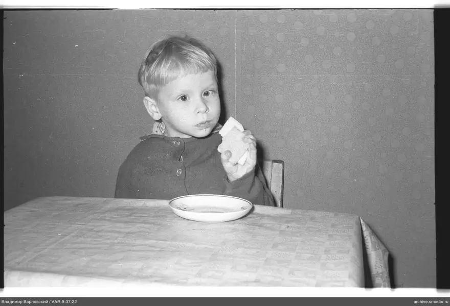 Child with bread at the table