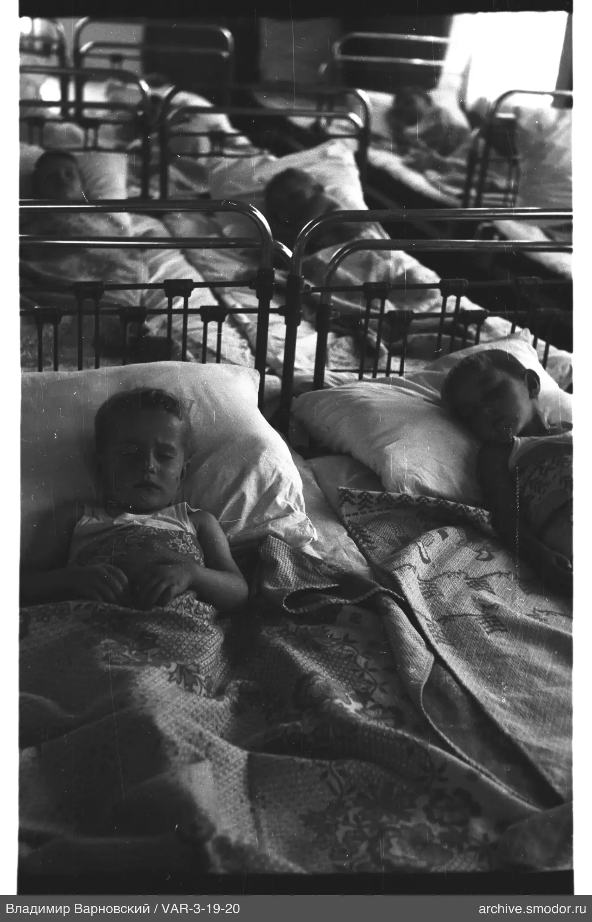 Children on metal beds in a room
