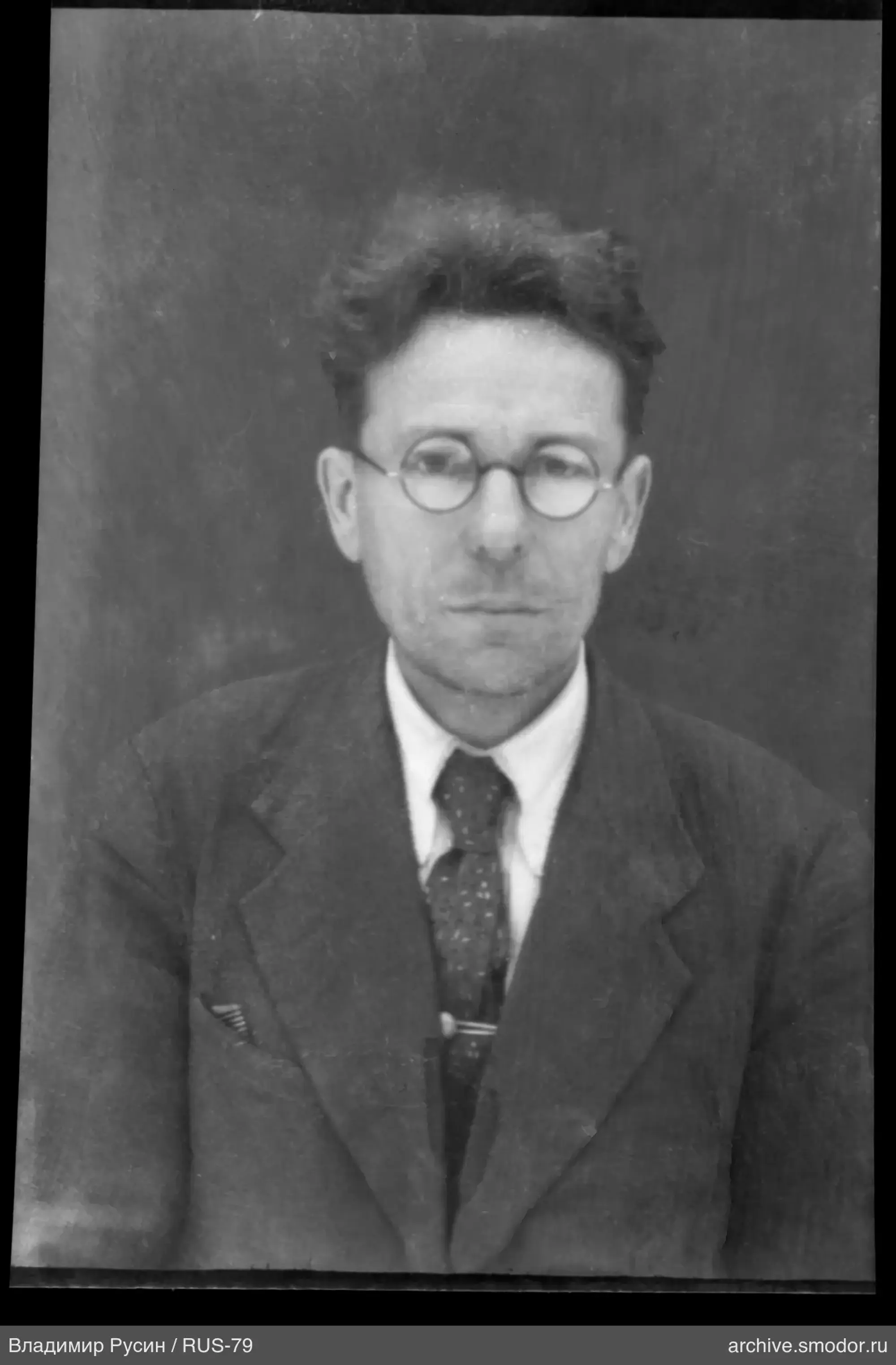 Full-length portrait of a man in glasses