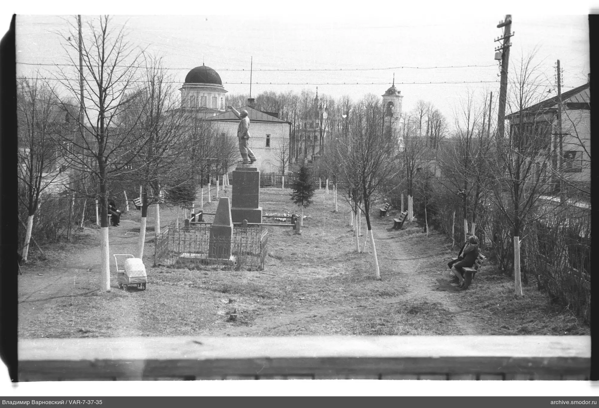 Park with monument and woman on bench
