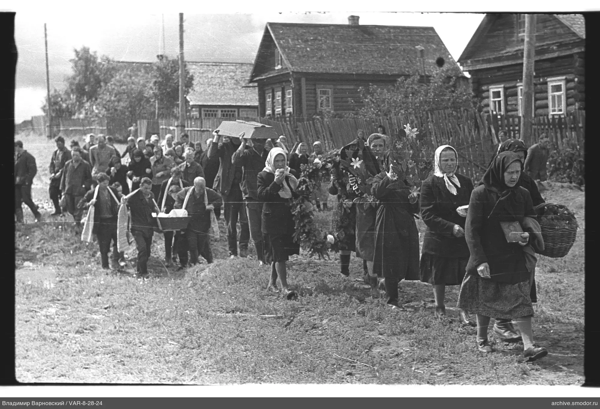 Group of people on the road with coffin and women