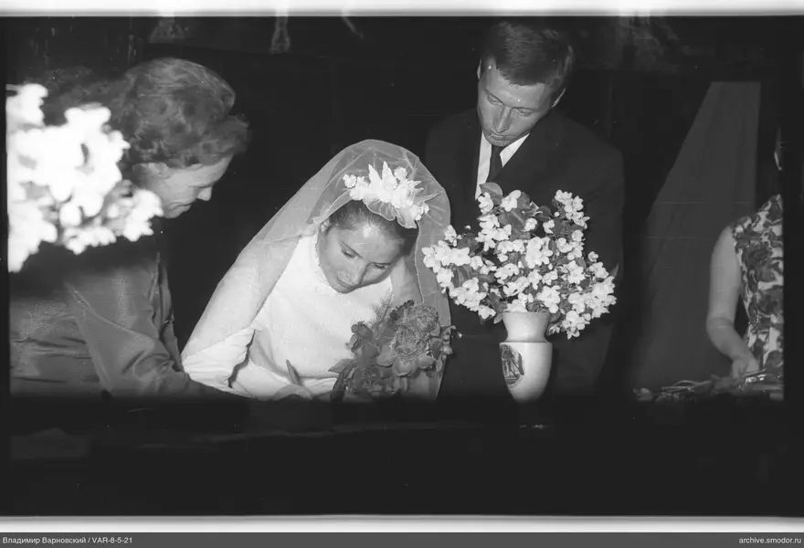 Woman in wedding dress signing a document