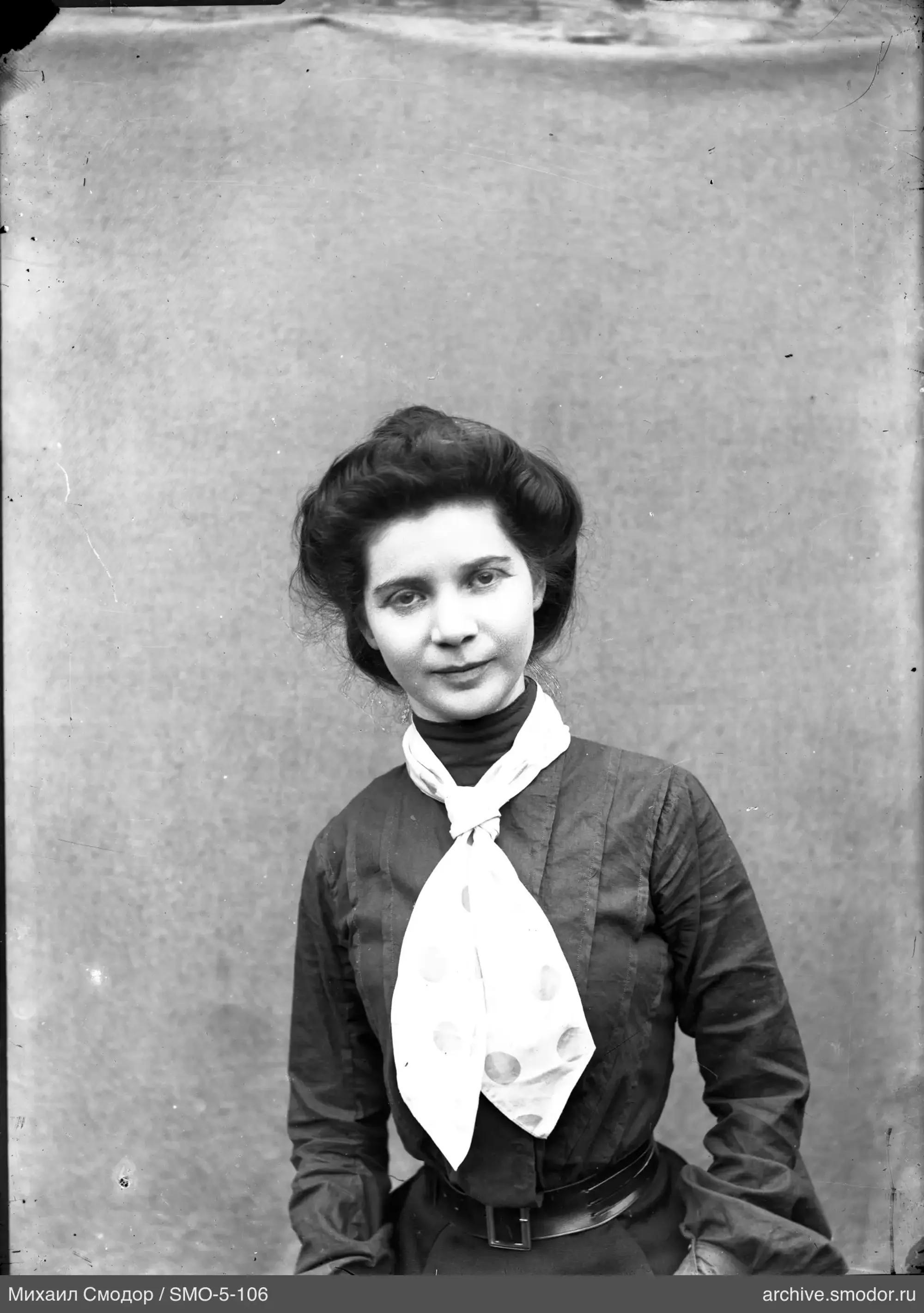 Portrait of a woman in a dark dress and white scarf