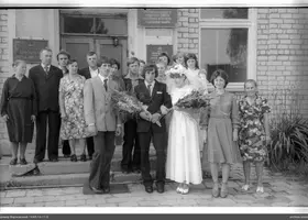 Group portrait in front of brick building