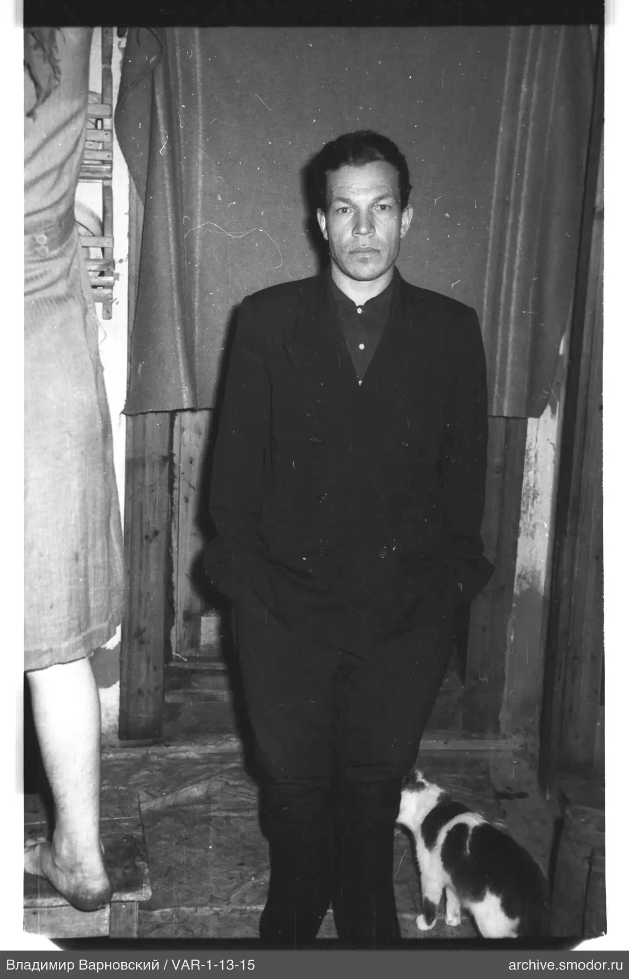 Full-length portrait of a man with a cat