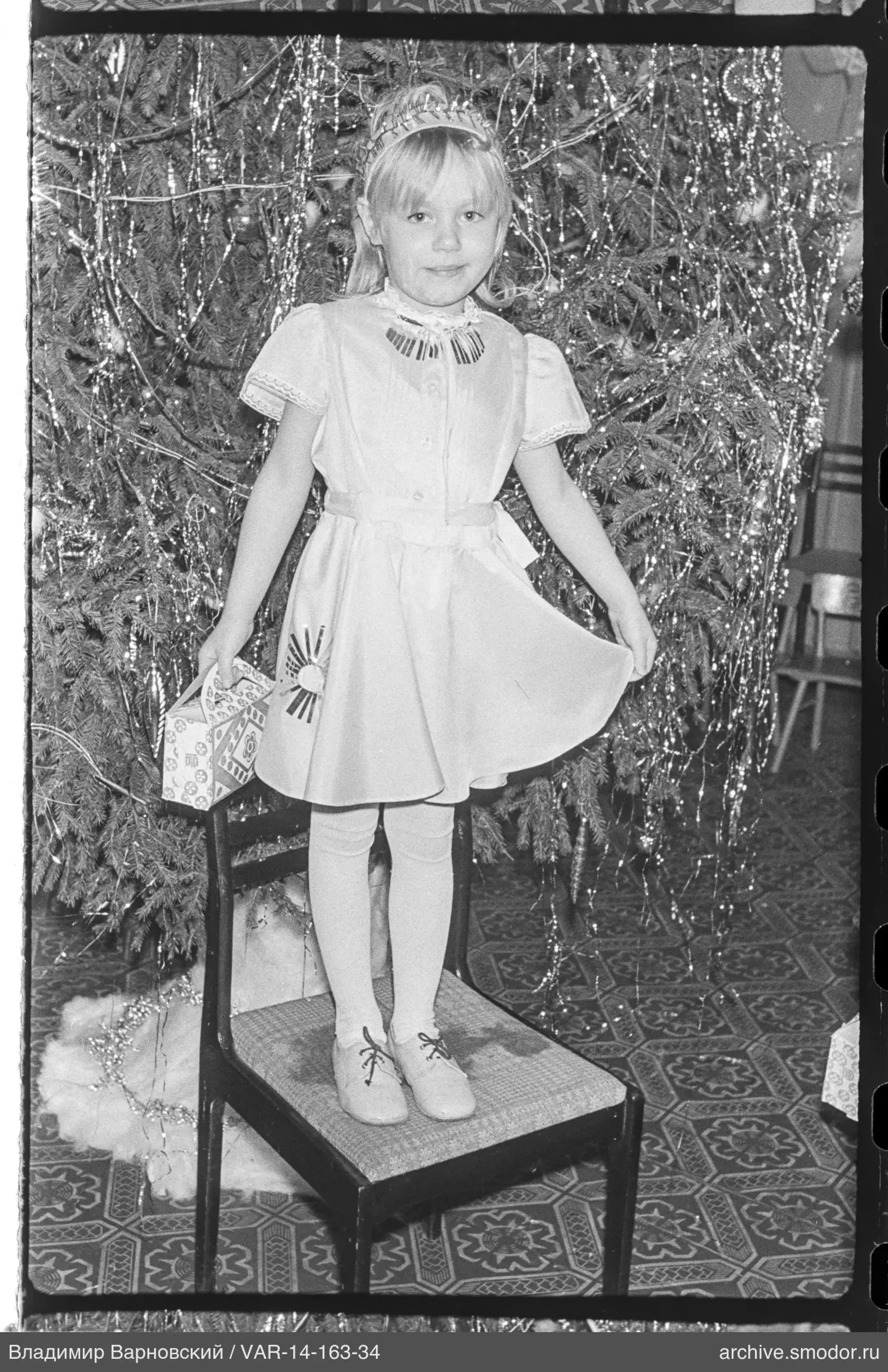 Girl in front of decorated Christmas tree