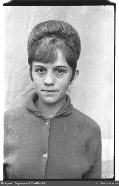Portrait of a woman with a bun and bangs