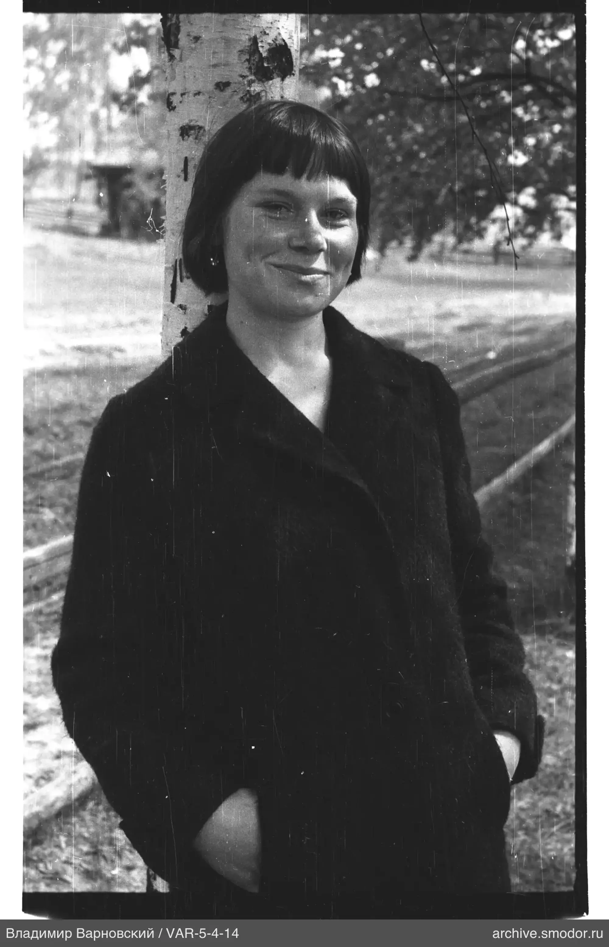 Portrait of a woman by a birch tree
