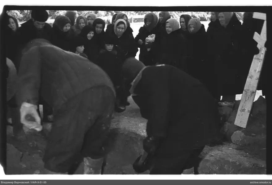 Group of people near a wooden cross