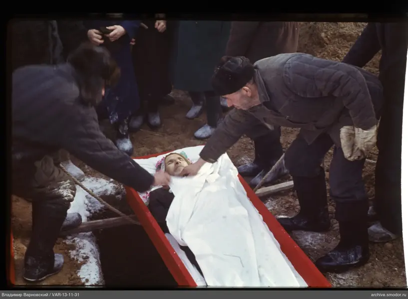 Men around a red coffin