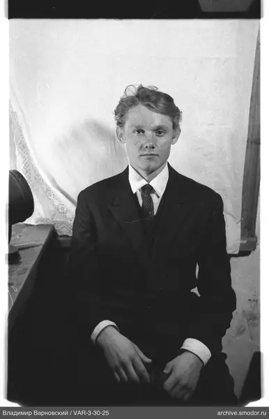 Man in suit with round object