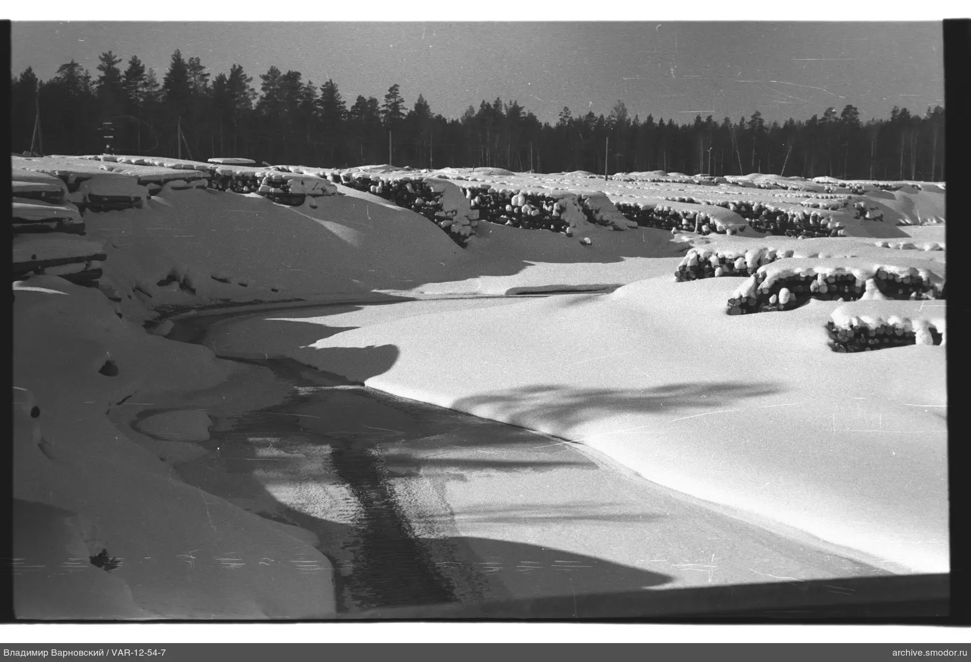 Winter landscape with river and logs