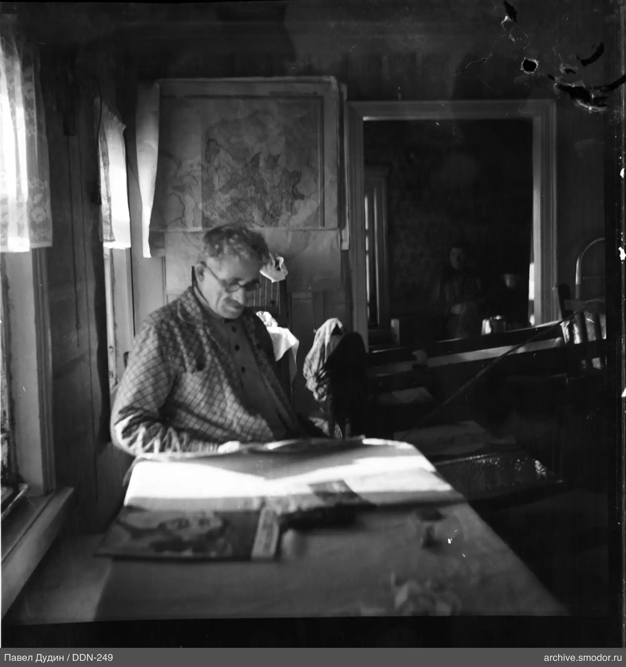 Man with papers and woman in room