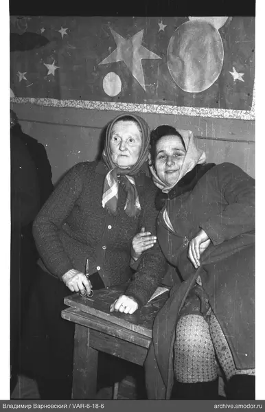 Two women at table with starry fabric background