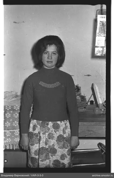 Woman in a dark sweater and floral skirt