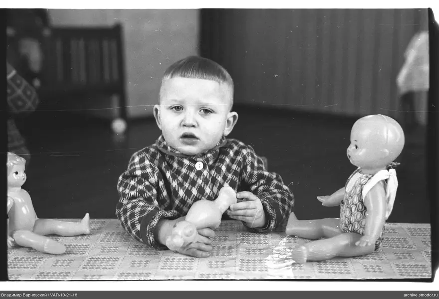 Boy with dolls at the table