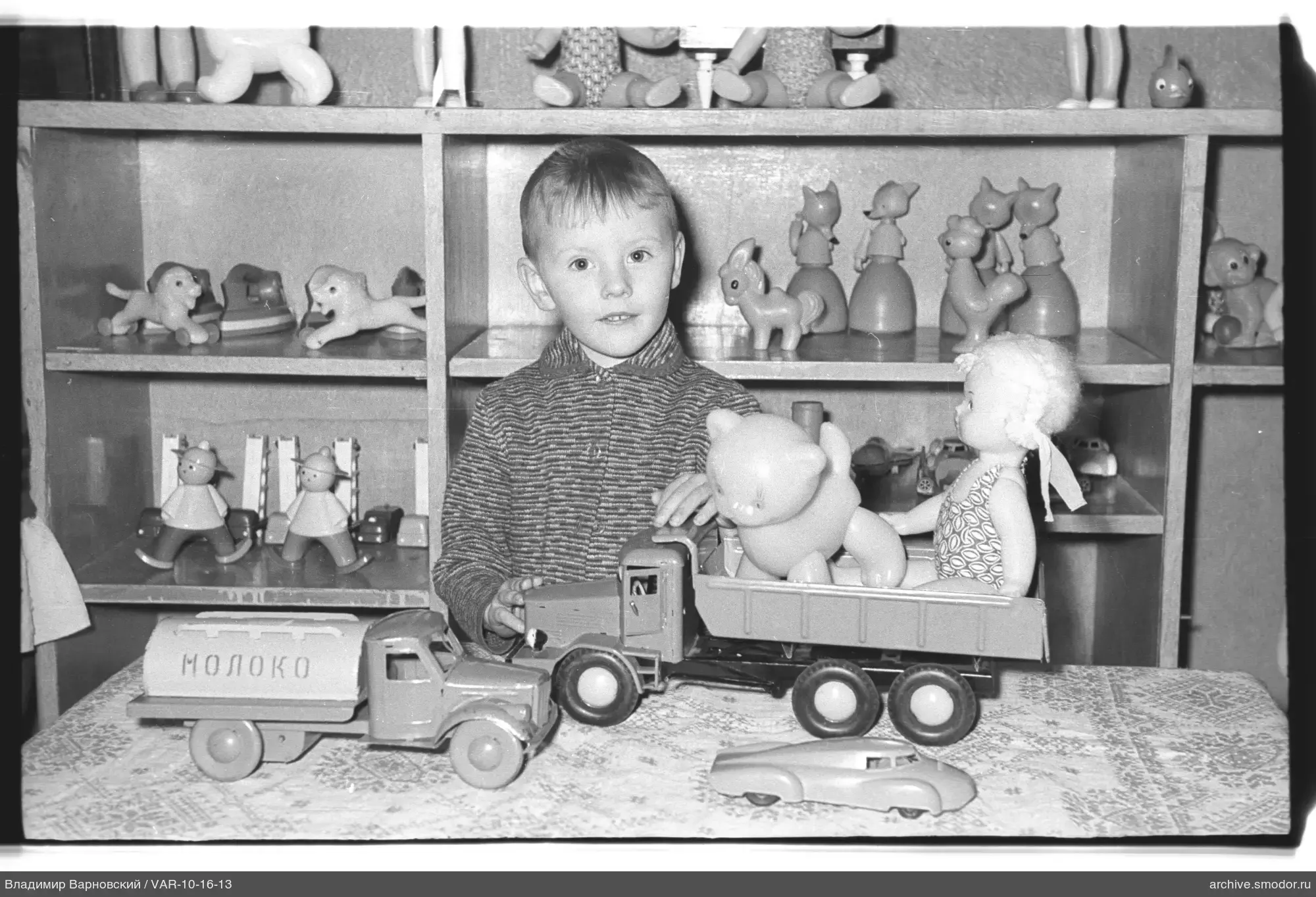 Kind mit Spielzeugautos und Spielzeug