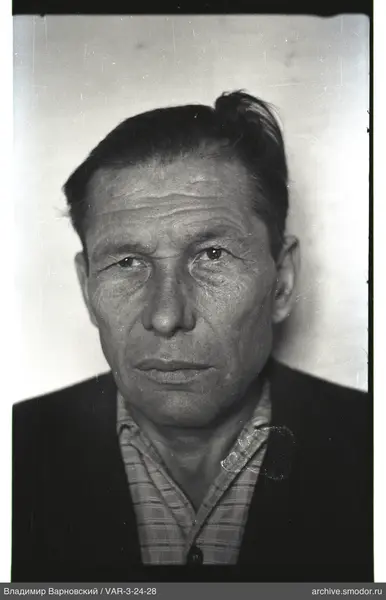 Close-up portrait of a man in a checkered shirt