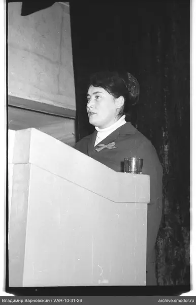 Portrait of a woman behind a podium