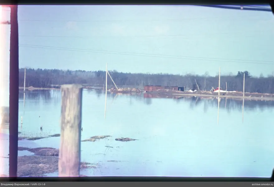 View of water and wooden post