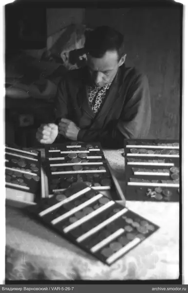 Man with coins at the table