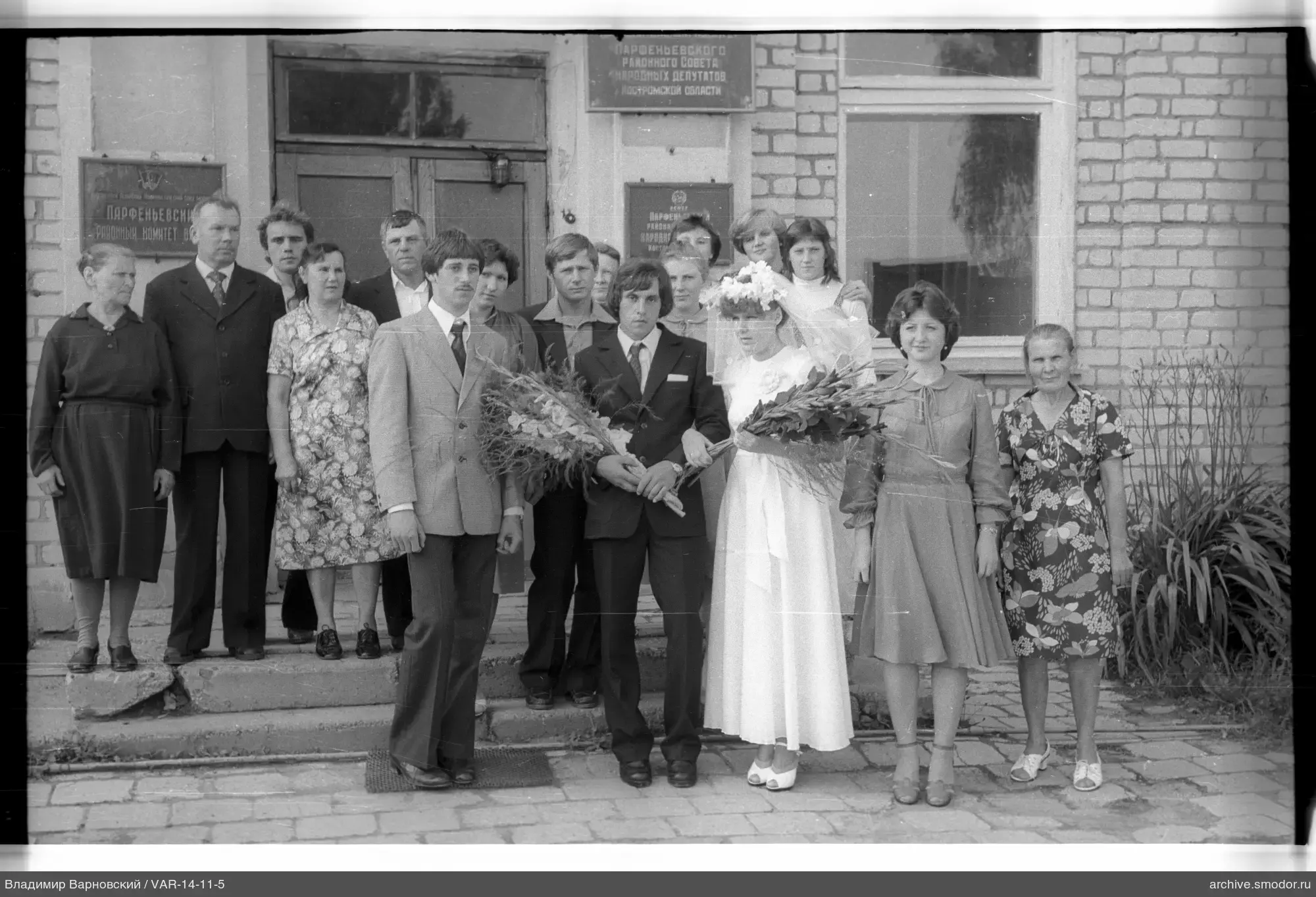 Group portrait in front of brick building