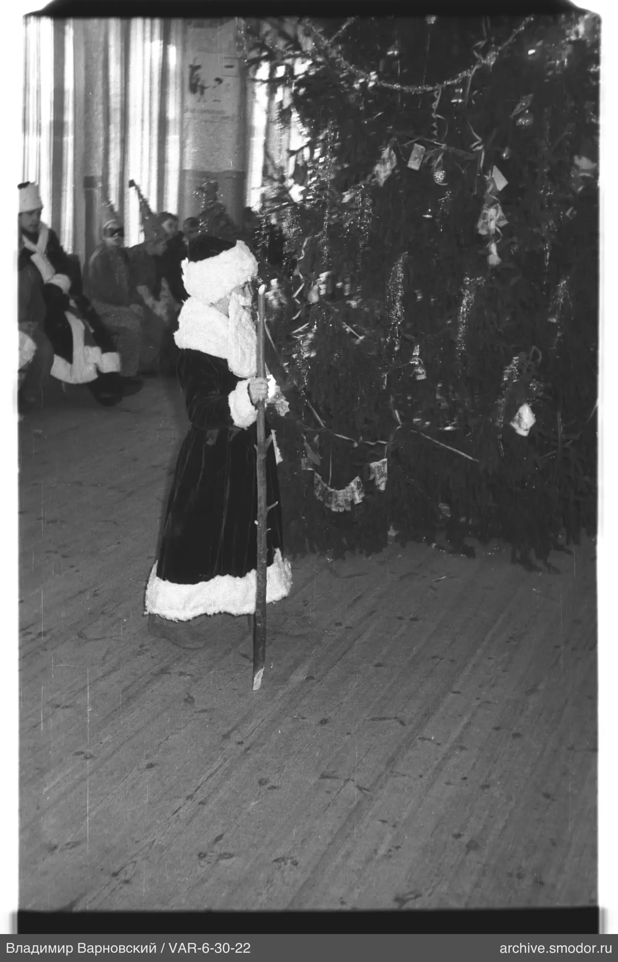 Child by decorated Christmas tree