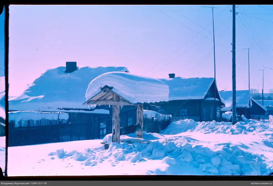 Wooden well roof with snow and icicles