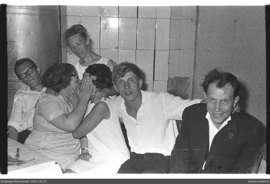 Gruppenporträt von sechs Personen an einer Fliesenwand