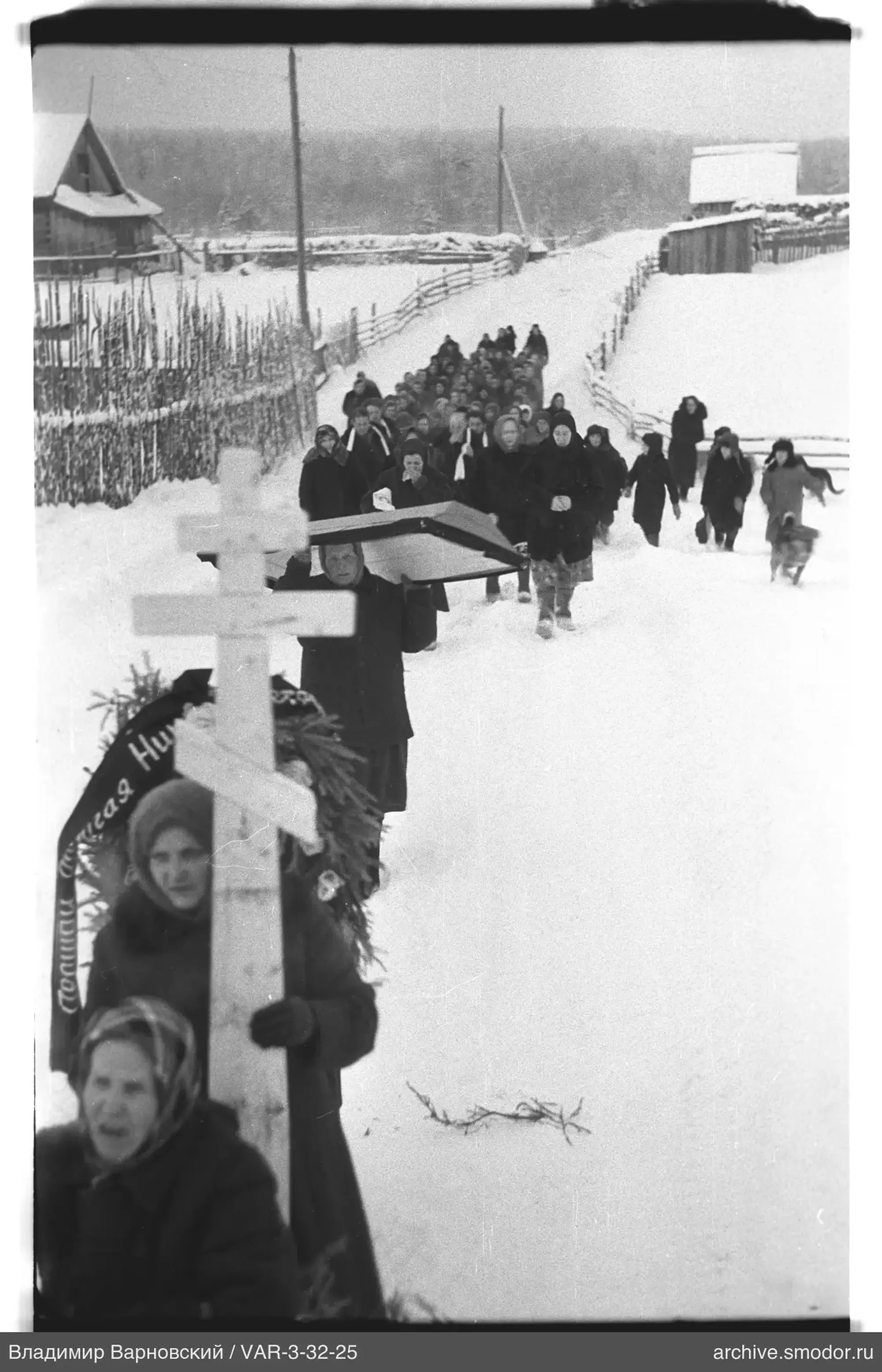 Procession with cross and coffin in snow
