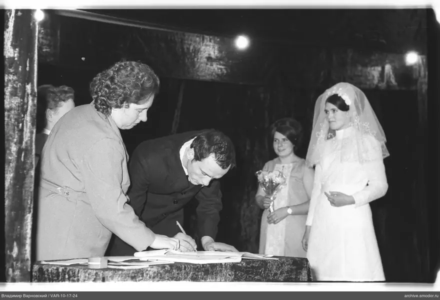 Man signing a document at an event