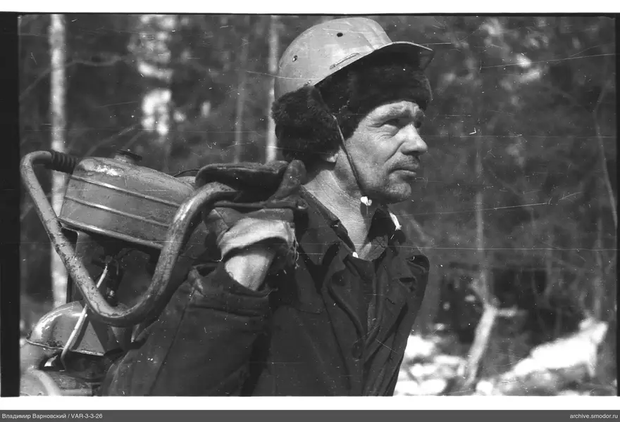 Profile portrait of a man with a metal tank and fur hat