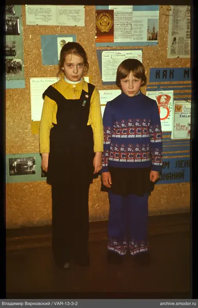 Two girls against an information board