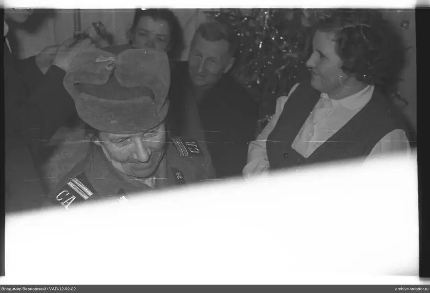 Group photo with woman in military uniform and guitar