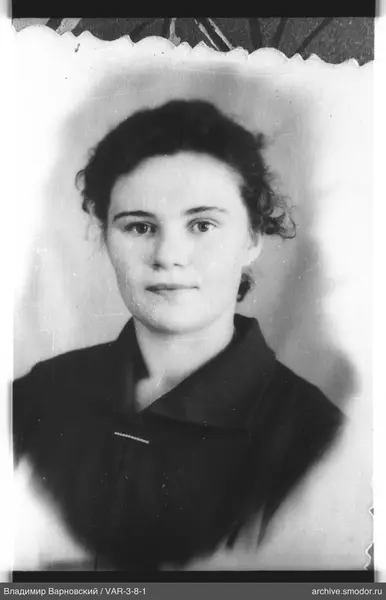 Portrait of a woman with dark curly hair