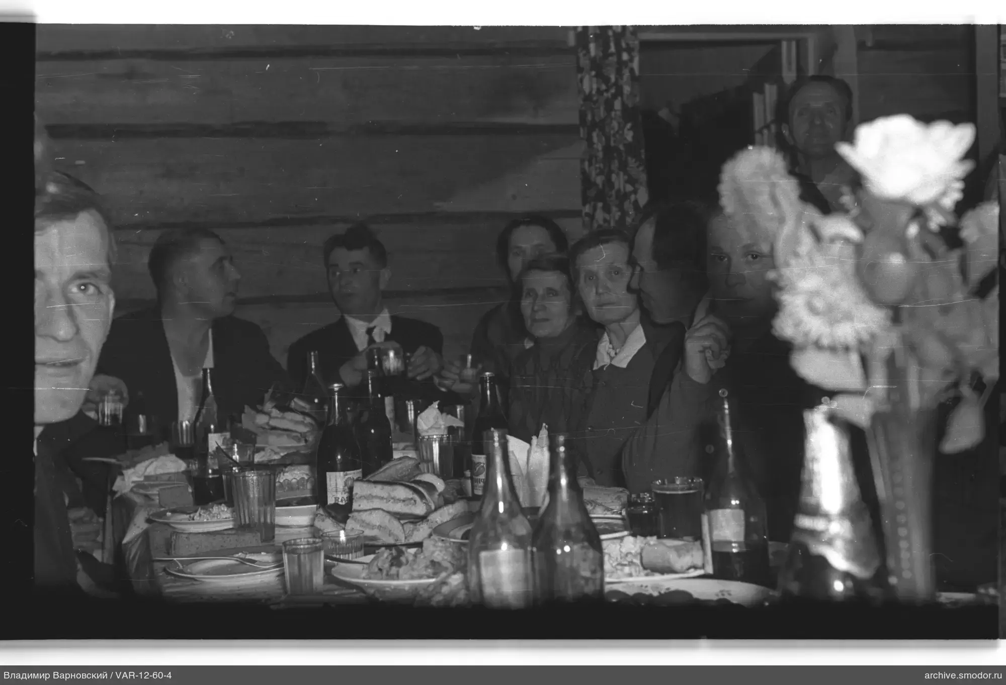 People sitting at a table with food and drinks