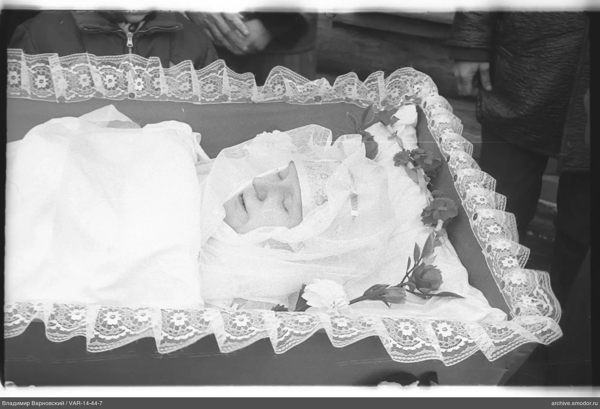 Person in a coffin with lace trim