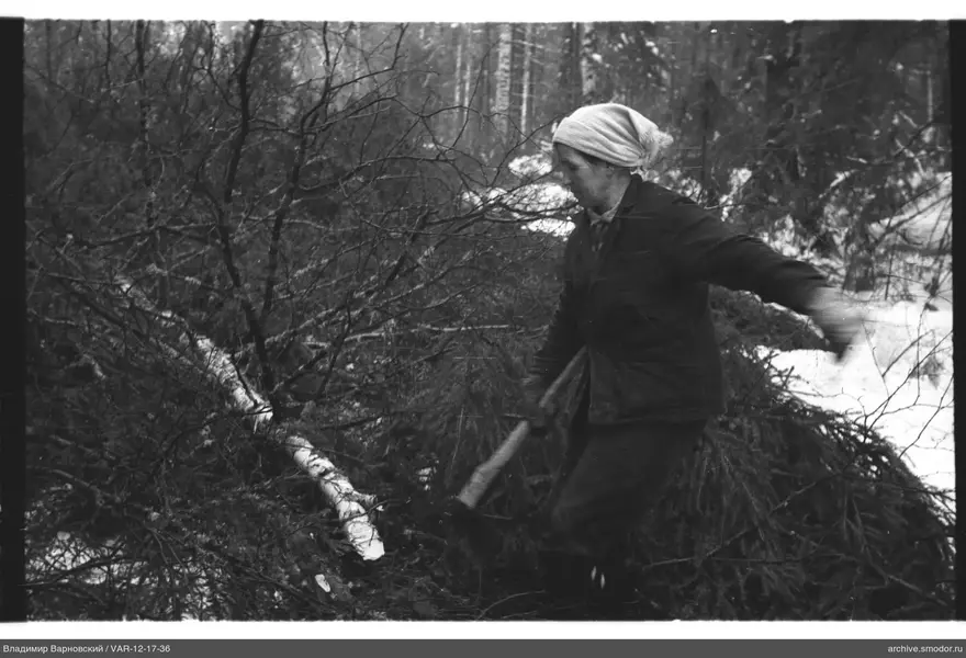 Woman with axe in forest