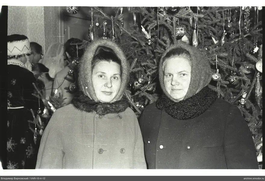 Two women in front of decorated Christmas tree